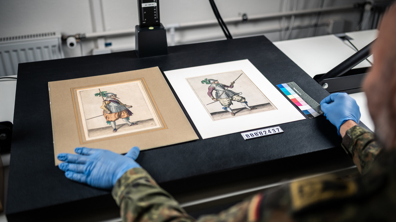 Prints and drawings being placed on a scanner ready for digitization. 