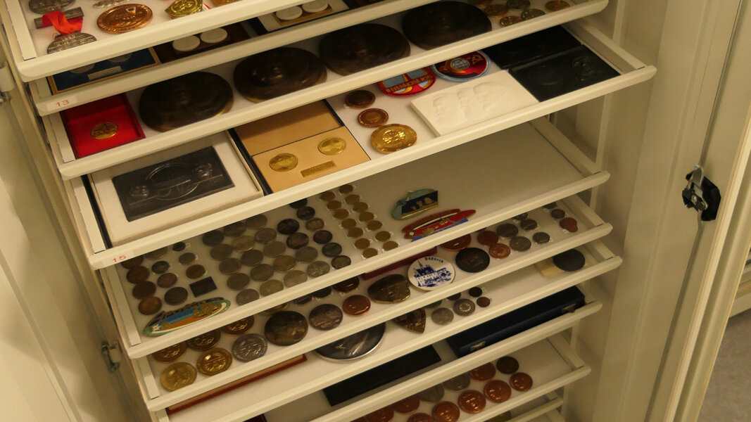 Cabinet containing various military decorations.  