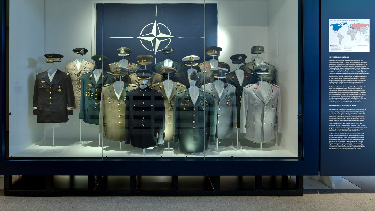 Display case on NATO with uniforms from different member countries. 