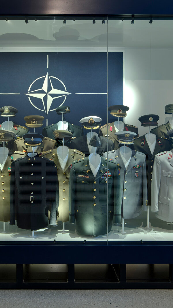 Display case on NATO with uniforms from different member countries. 