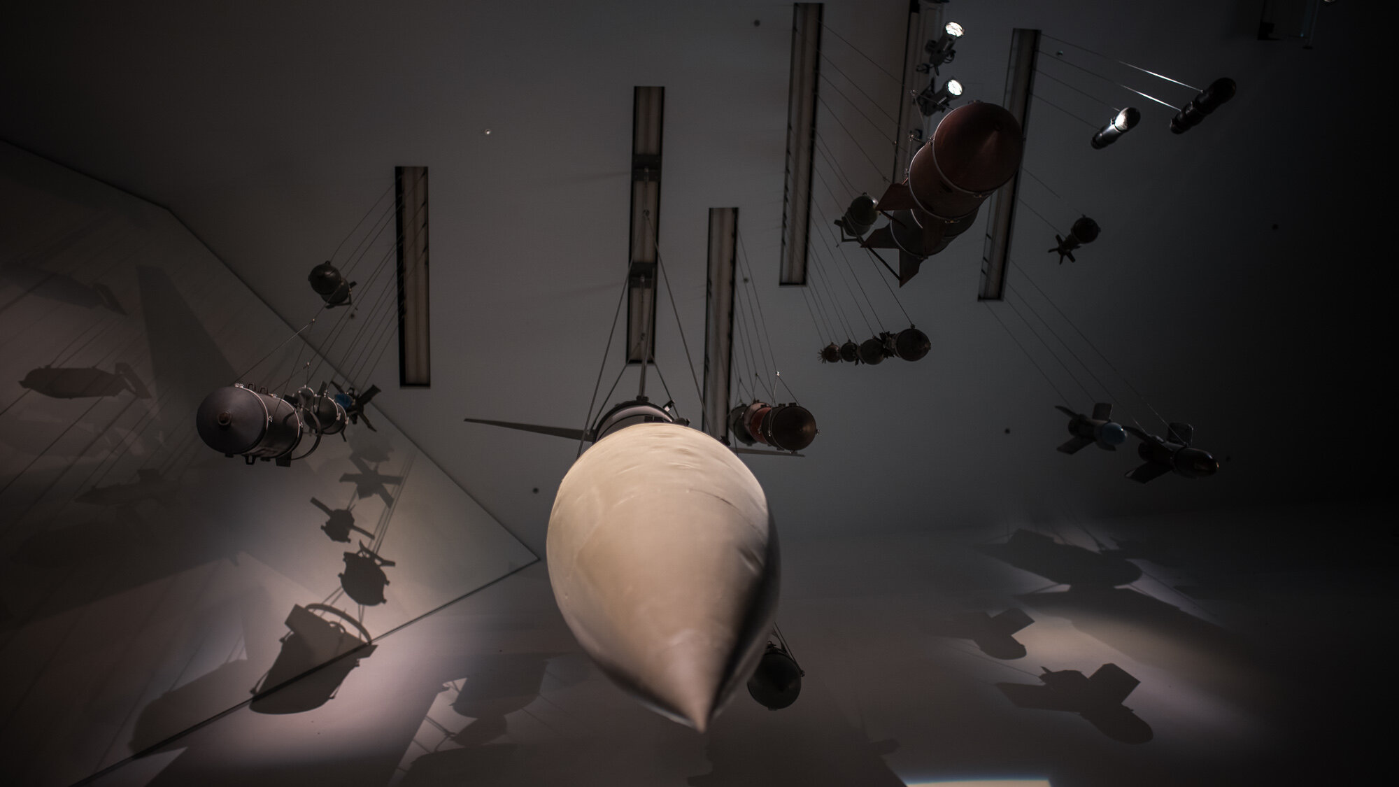 Das Bild zeigt eine Auswahl an Bomben, die von der Decke herunterhängen, als würden sie fallen. 