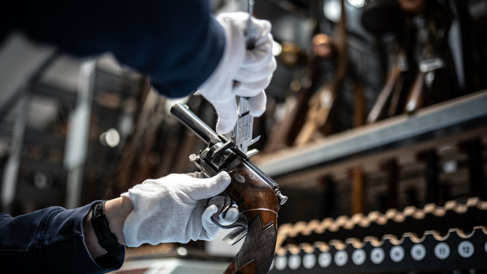 Measuring the cylinder of a needle-fire revolver with callipers. 